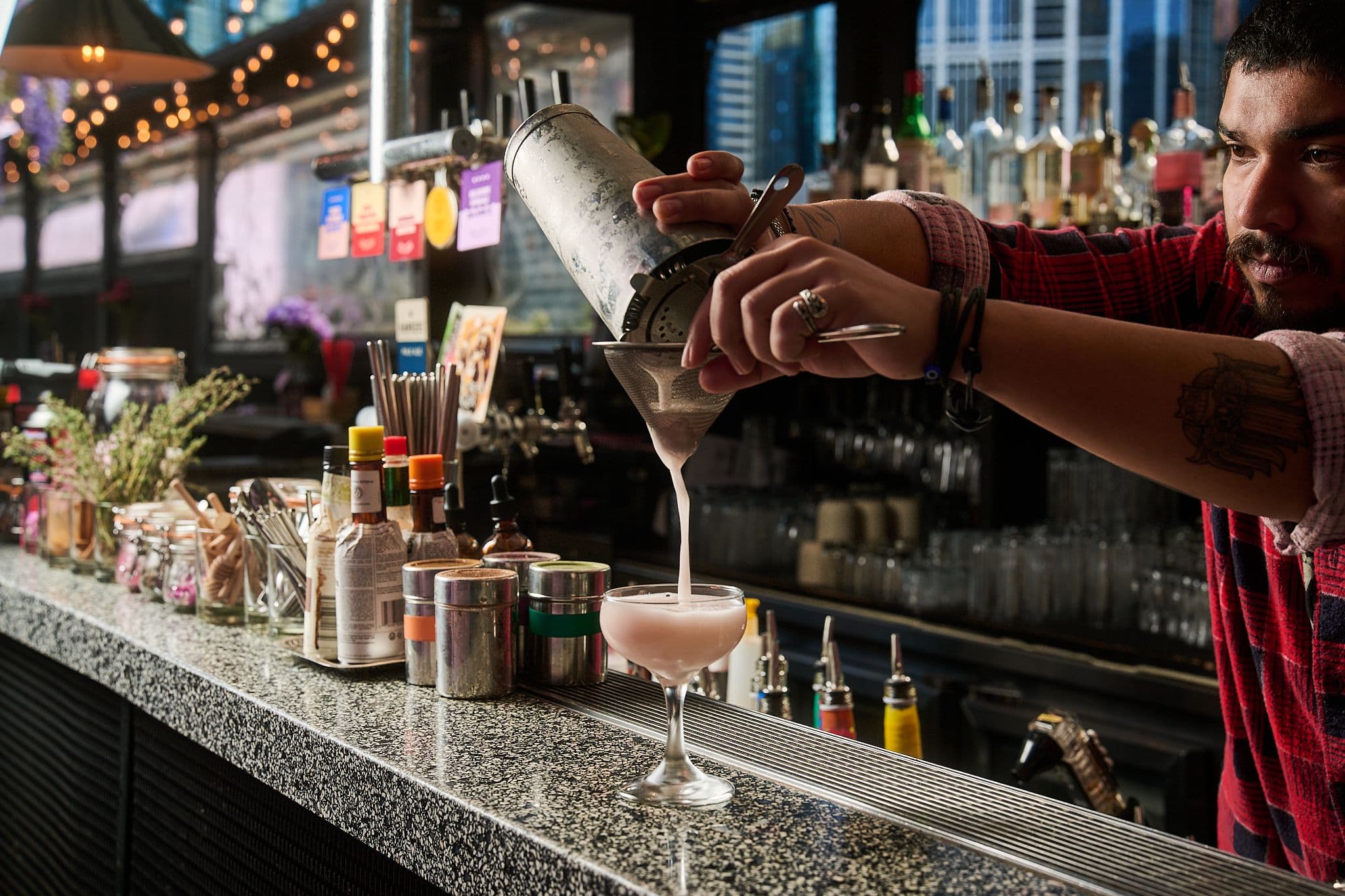 making cocktail at Goldilocks rooftop bar